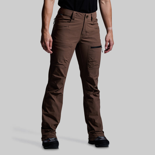 Brown outdoor pants worn by a person on a gray background