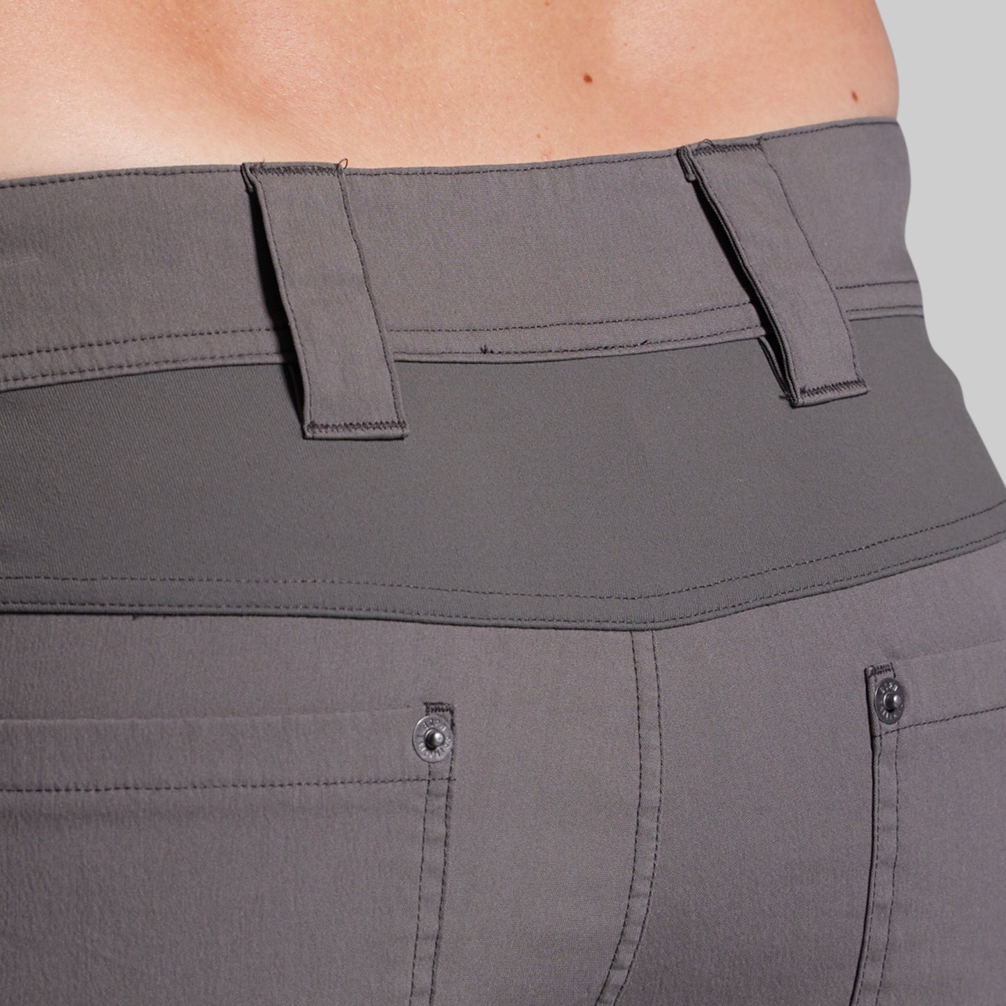 Close-up of gray shorts with a focus on the waistband and pockets.
