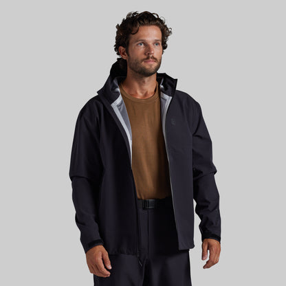 Man wearing the black Mission FLEX Rain Jacket 2.0 open over a base layer