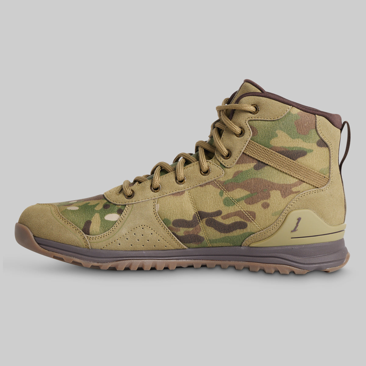 A high-top tactical combat boot in a tan and green camouflage pattern, shown from the side against a solid gray background.