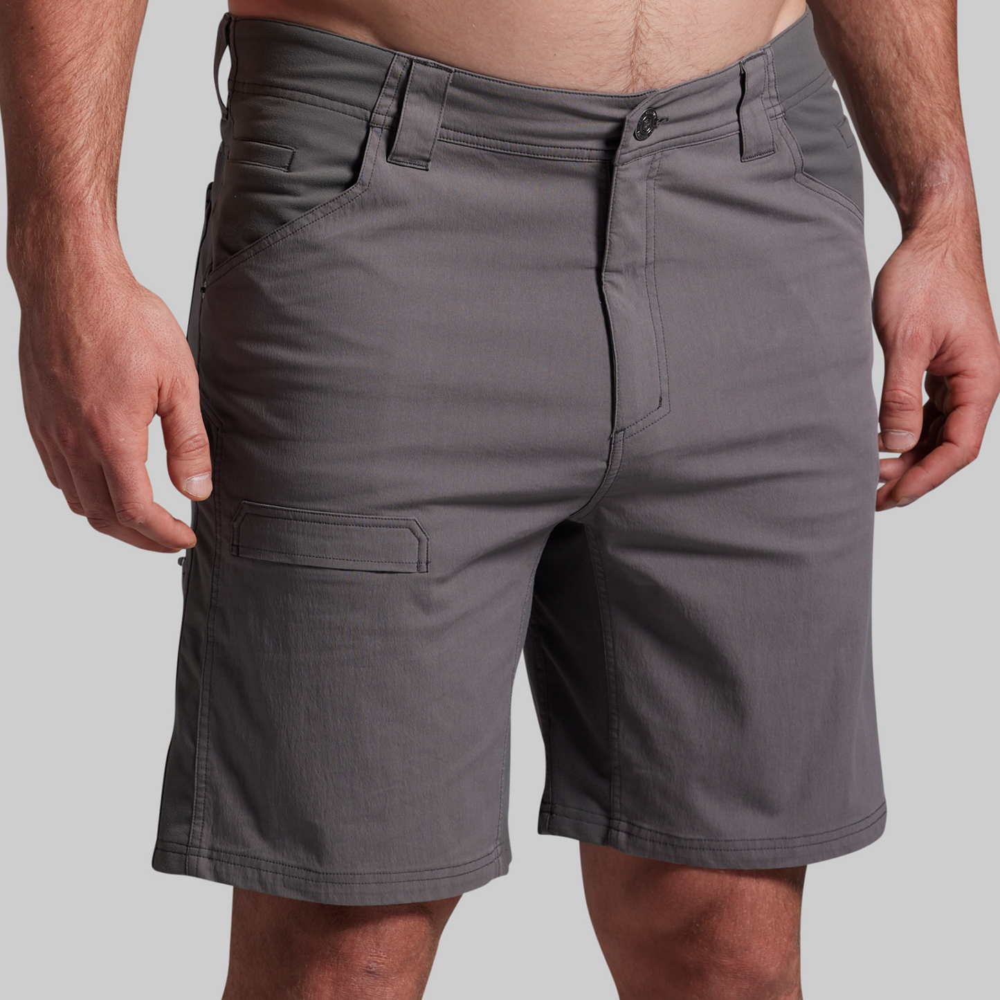 Gray shorts worn by a person on a plain background