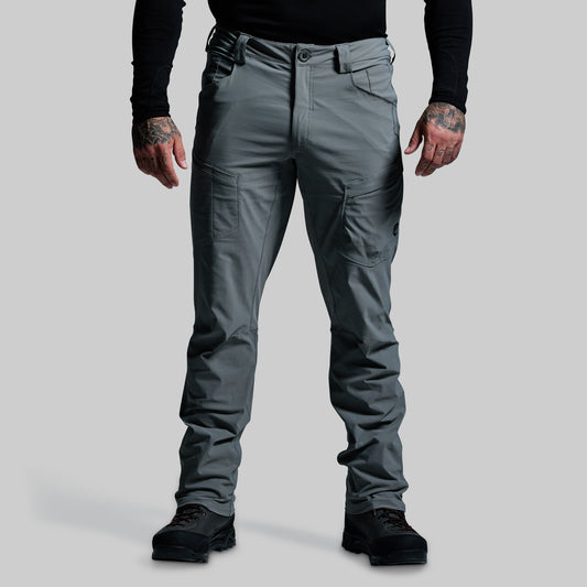 Person wearing gray outdoor pants on a light gray background