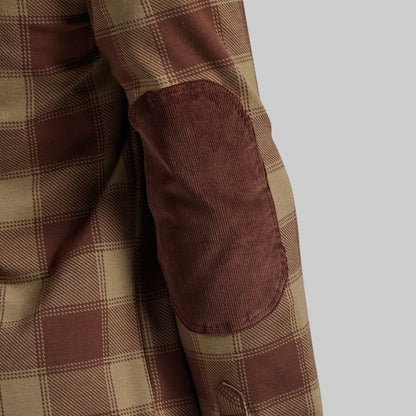Close-up of a brown and beige plaid jacket or shirt sleeve with a brown corduroy elbow patch on a light gray background.