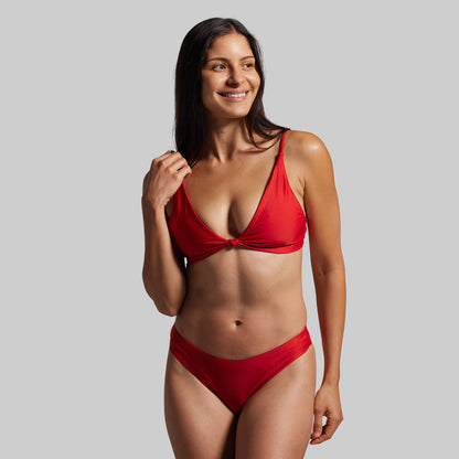 Woman wearing a red bikini against a gray background