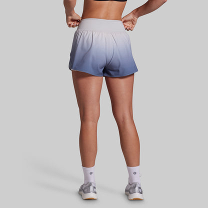 Person wearing gradient shorts on a plain background