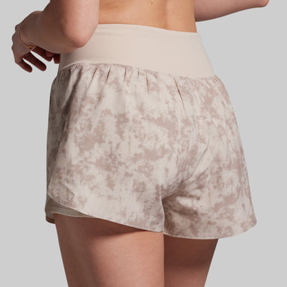 Beige patterned shorts worn by a person on a plain background
