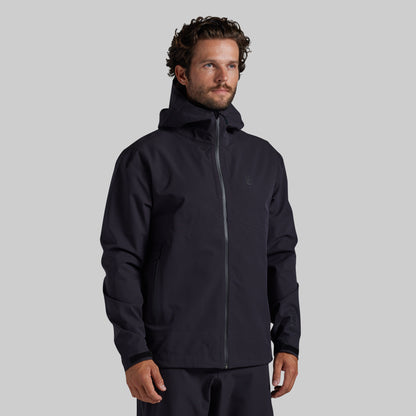 Man wearing the black Mission FLEX Rain Jacket 2.0, front view with hood down