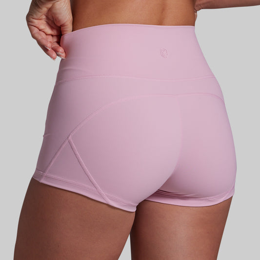 Pink athletic shorts worn by a person on a plain background