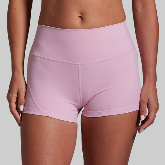 Pink athletic shorts worn by a person on a gray background