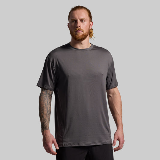 Man wearing a gray t-shirt against a plain background