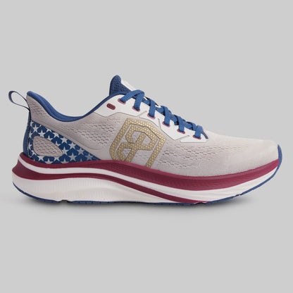White running shoe with blue and red accents on a gray background