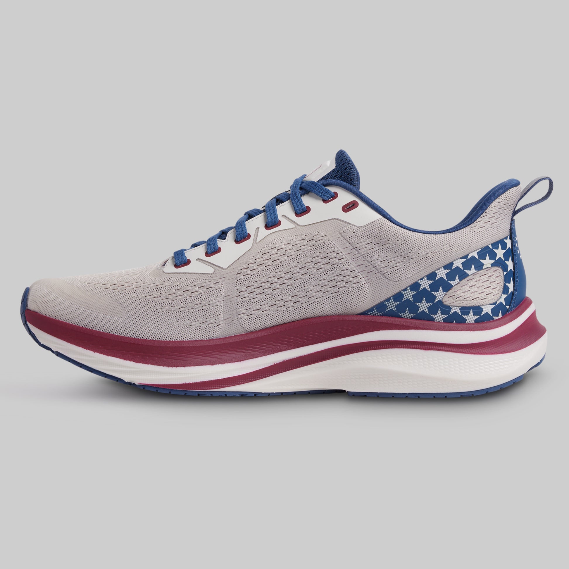 Gray running shoe with blue and red accents on a gray background