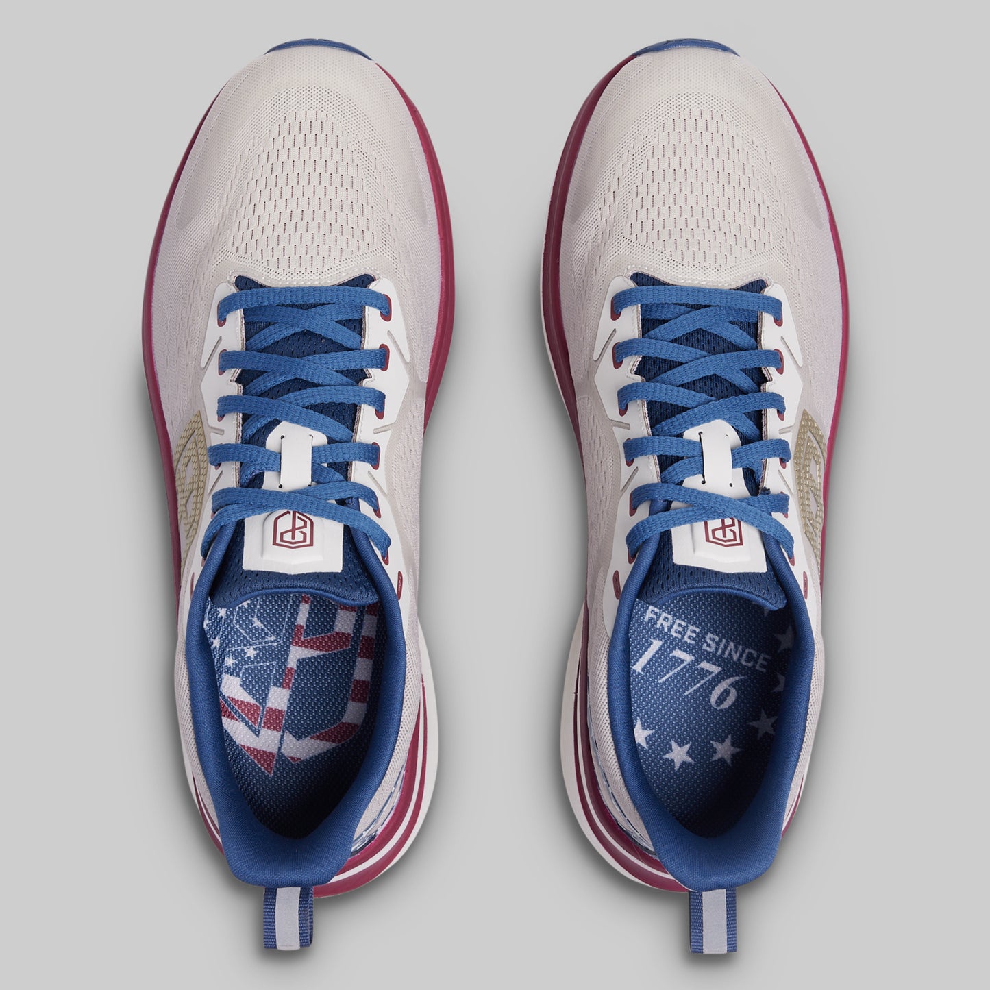 Pair of running shoes with blue laces and American flag design on a gray background