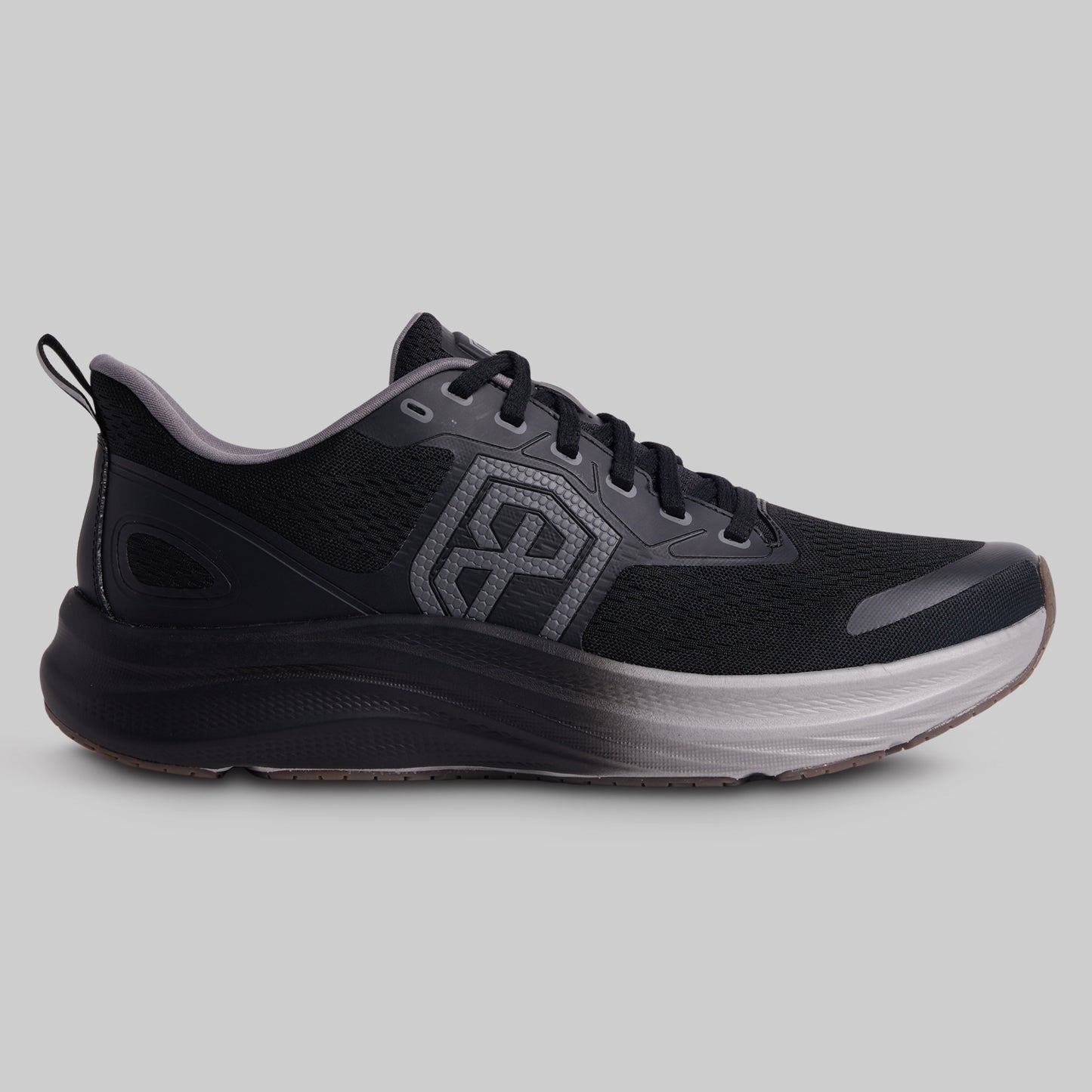 Black running shoe with a visible brand logo on a gray background