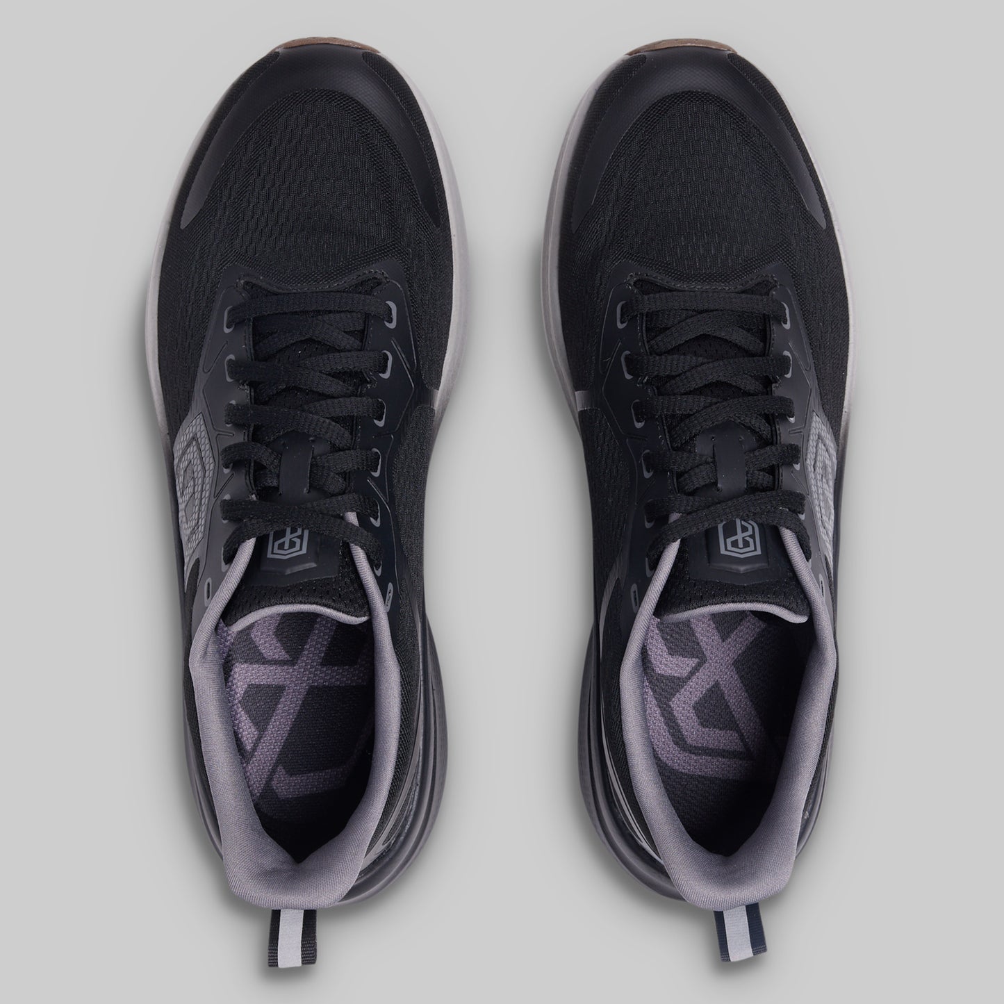 Black and gray athletic shoes on a light gray background