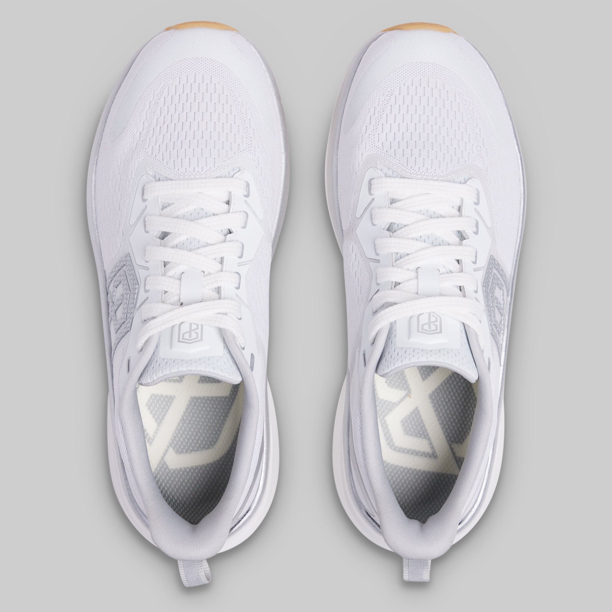 White athletic shoes on a gray background