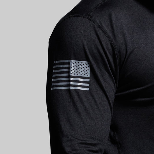 Close-up of flag on shoulder of a black long-sleeve shirt.