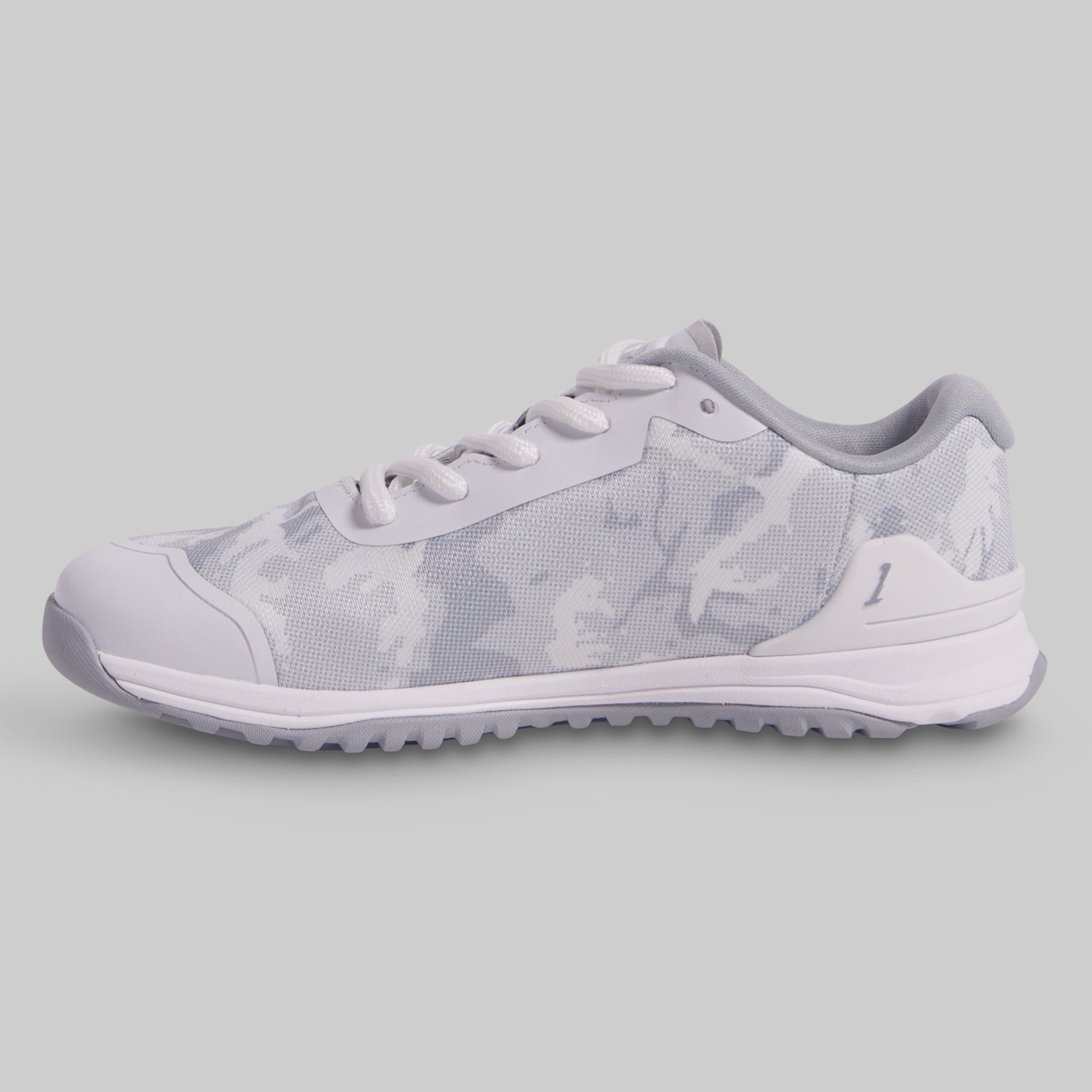 White sneaker with subtle pattern on a light gray background