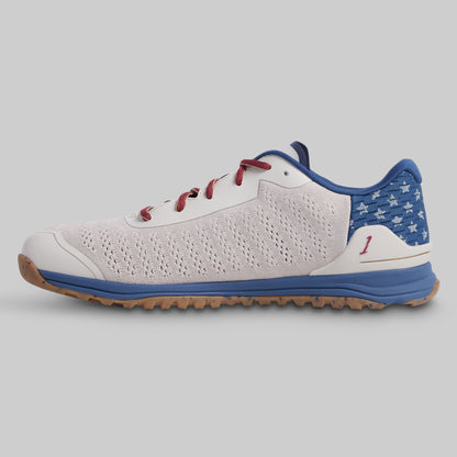 White and blue sneaker with red accents on a gray background