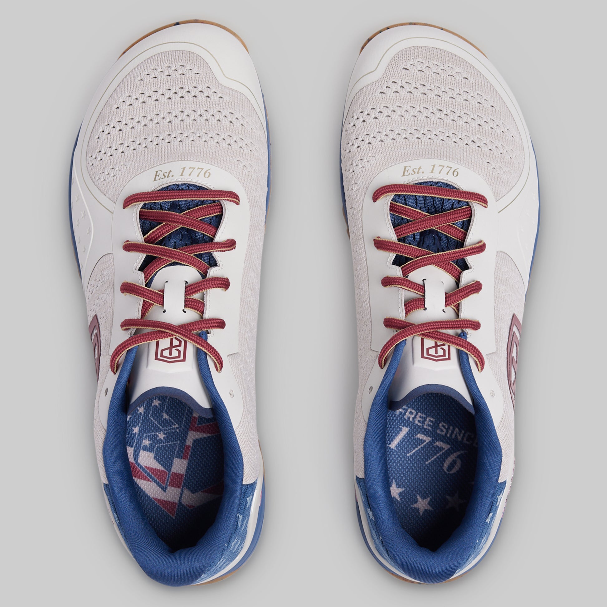 White sneakers with red and blue accents on a gray background