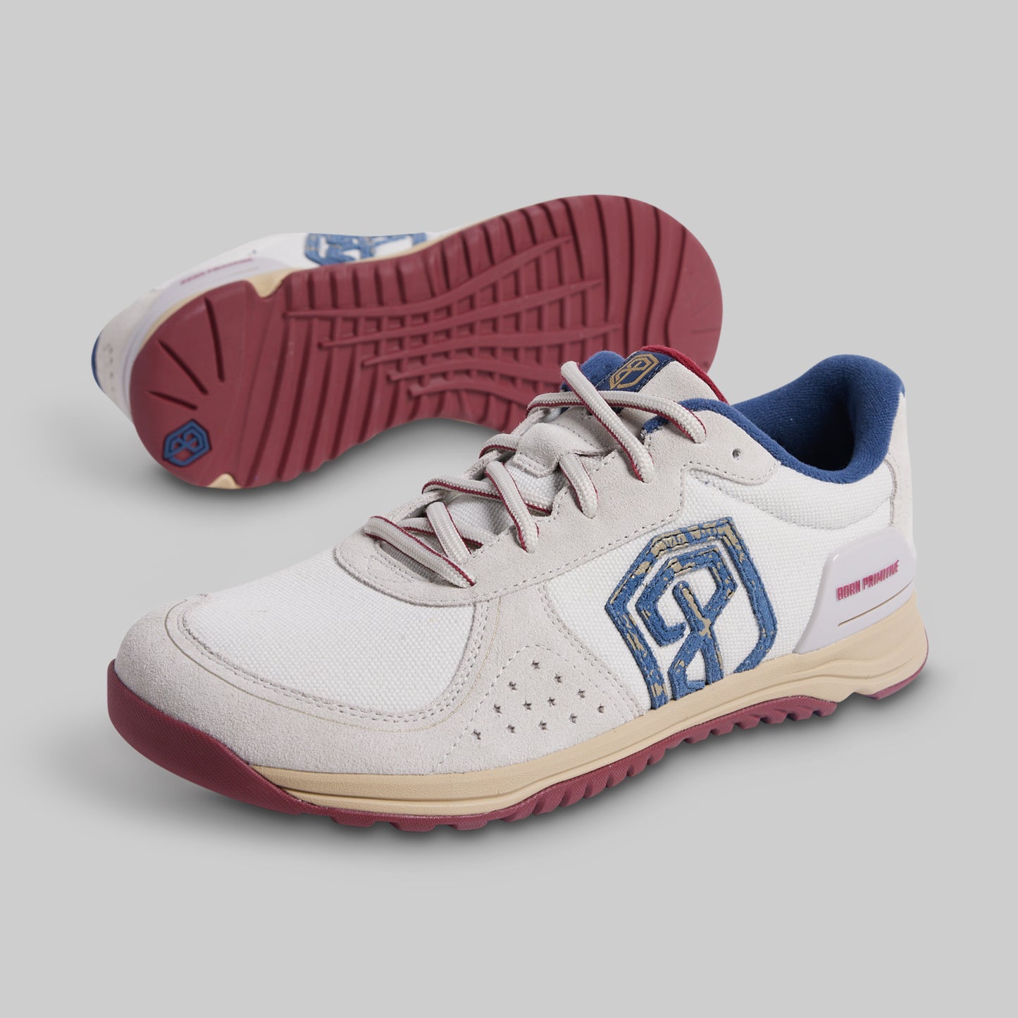 White sneakers with blue and red accents on a gray background