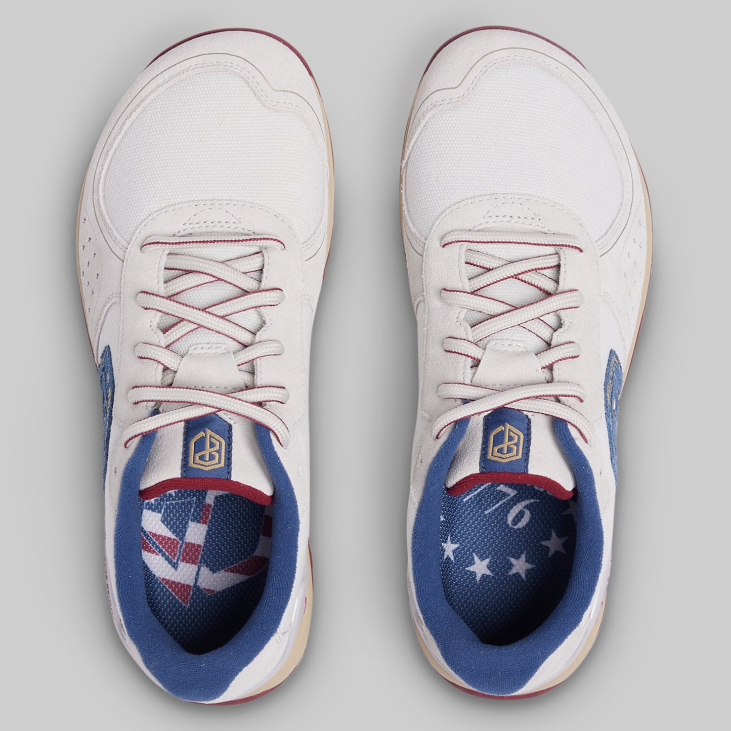 White sneakers with blue and red accents on a gray background