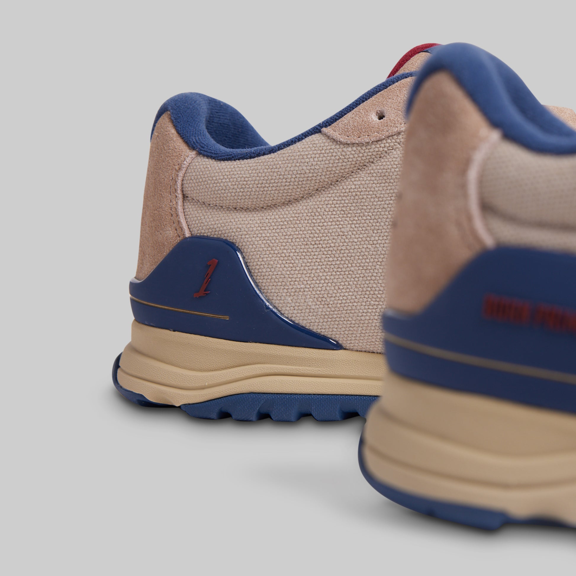 Beige and blue sneakers on a light gray background