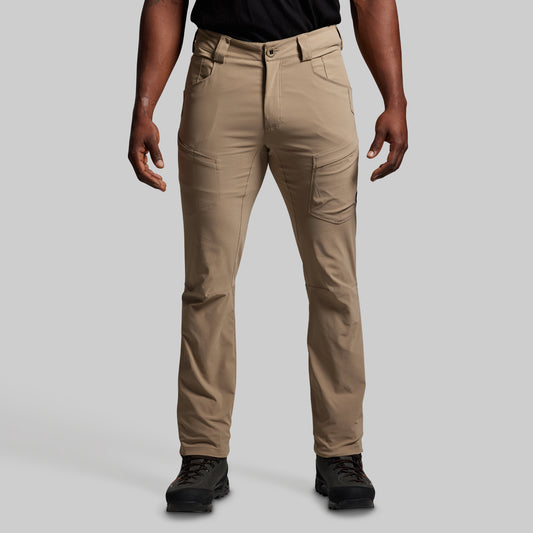 Beige pants worn by a person on a gray background
