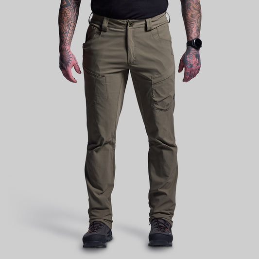 Person wearing green outdoor pants on a gray background