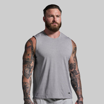 Man wearing a gray sleeveless shirt against a plain background
