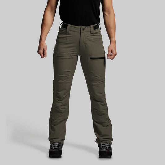 Person wearing olive green outdoor pants on a gray background
