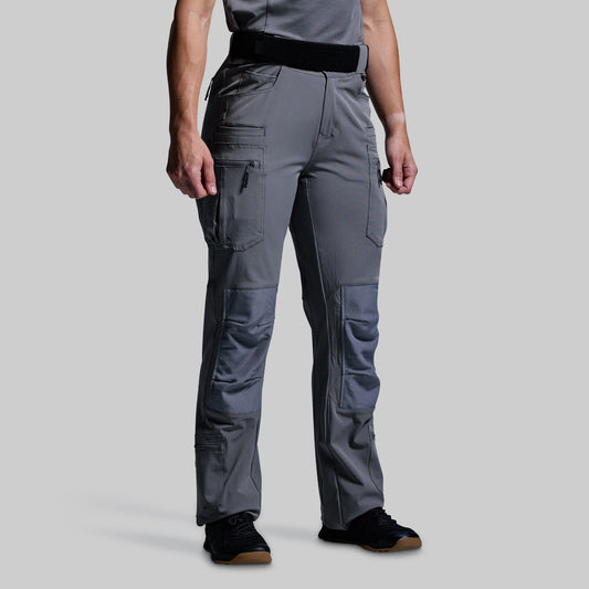 Person wearing gray tactical pants on a light gray background