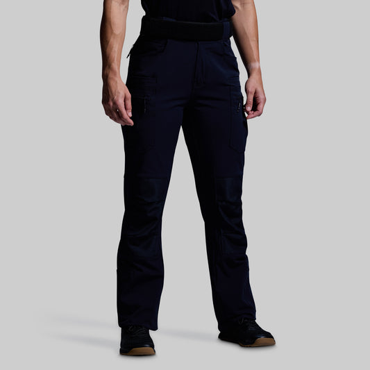 Person wearing dark blue pants on a light gray background