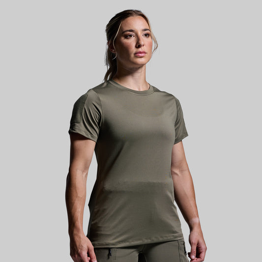 Woman wearing an olive green t-shirt against a plain background