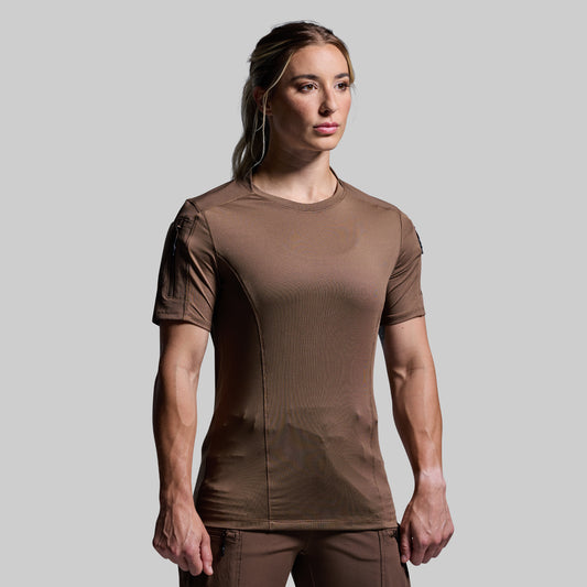 Person wearing a brown t-shirt on a plain background