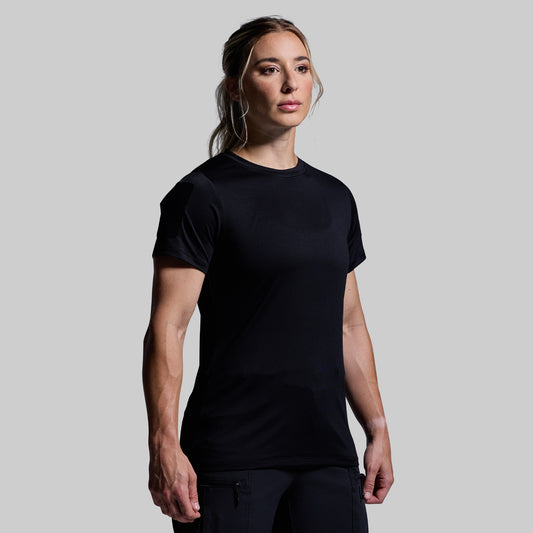 Person wearing a black t-shirt against a plain background