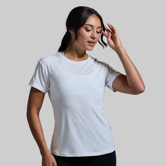 Woman wearing a plain white t-shirt against a light gray background