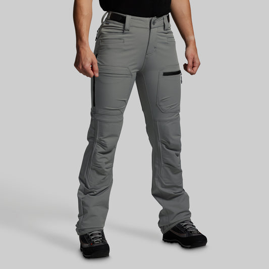 Person wearing gray outdoor pants on a light gray background
