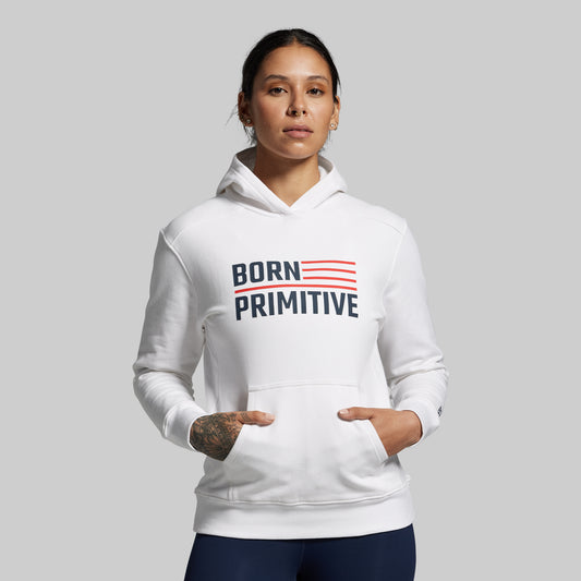 Person wearing a white hoodie with 'Born Primitive' text on a gray background