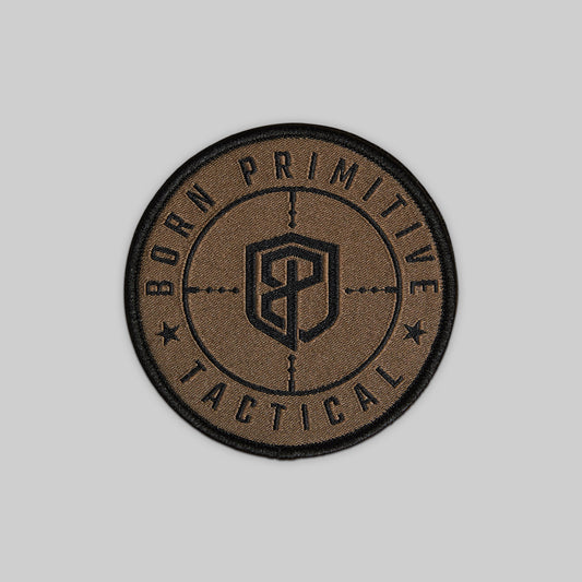 Brown and black patch with 'Born Primitive Tactical' text on a gray background