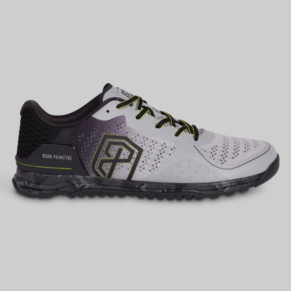 Gray athletic shoe with black and green accents on a gray background
