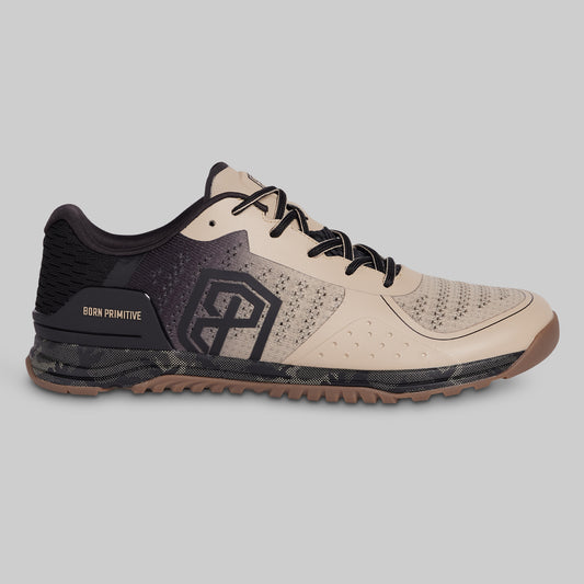 Beige and black athletic shoe on a gray background