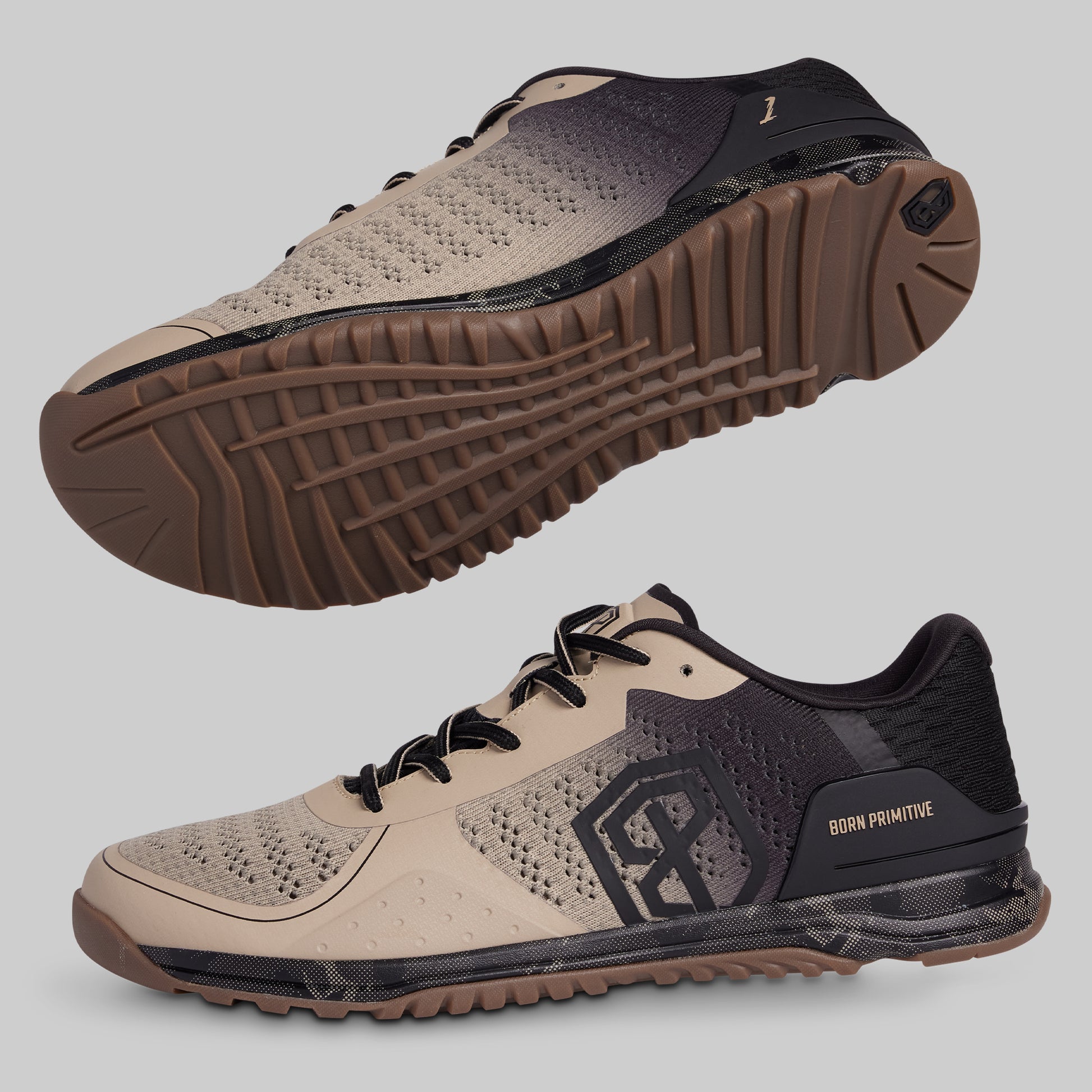 Beige and black athletic shoes with a prominent sole on a gray background