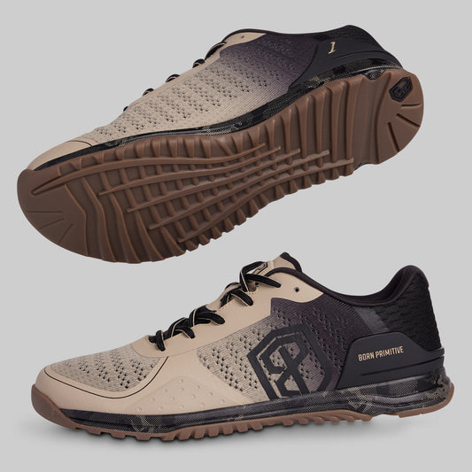 Beige and black athletic shoes with a prominent sole on a gray background