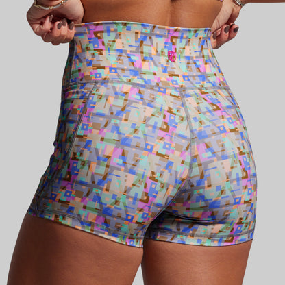 Colorful geometric patterned shorts on a plain background