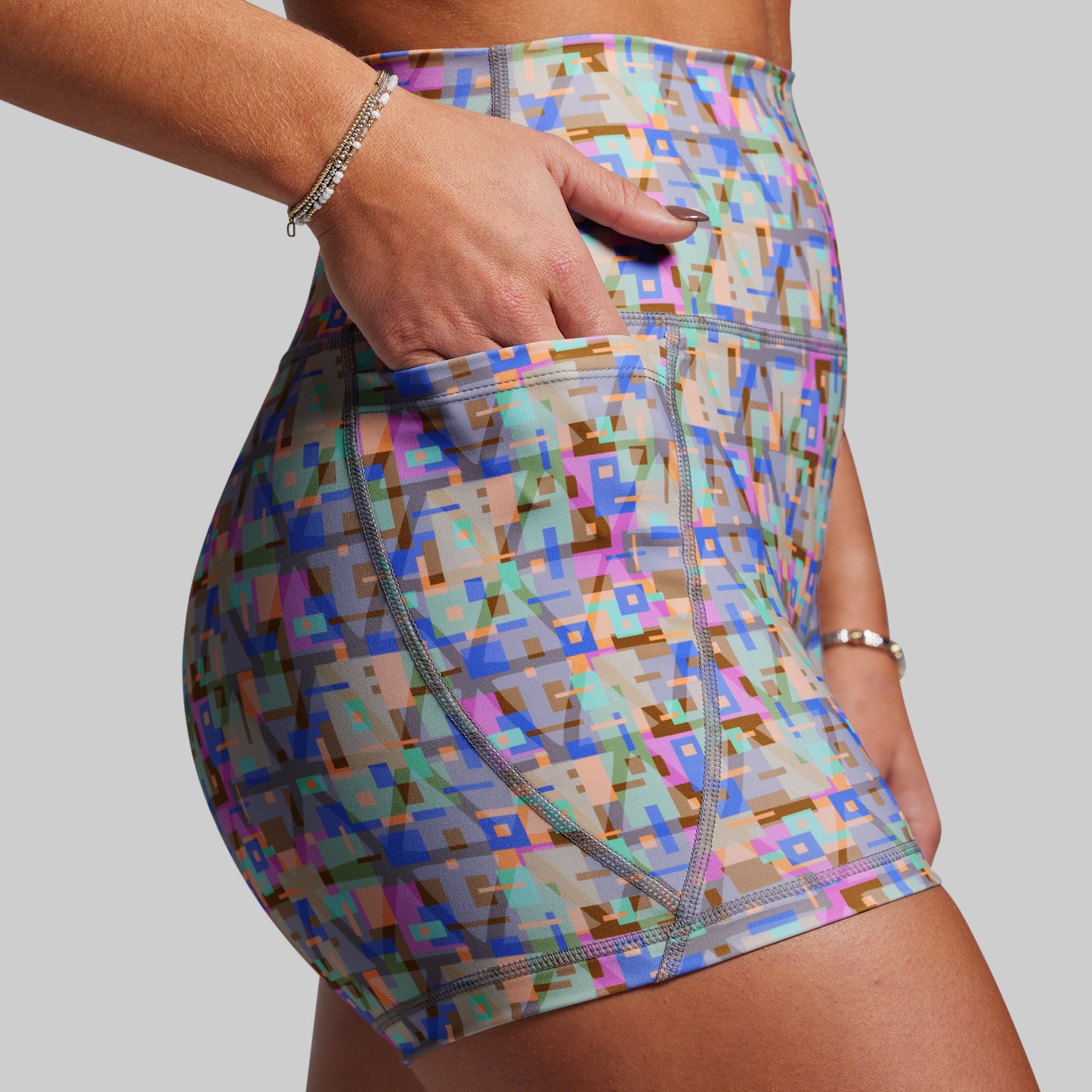 Multicolored geometric patterned shorts on a plain background
