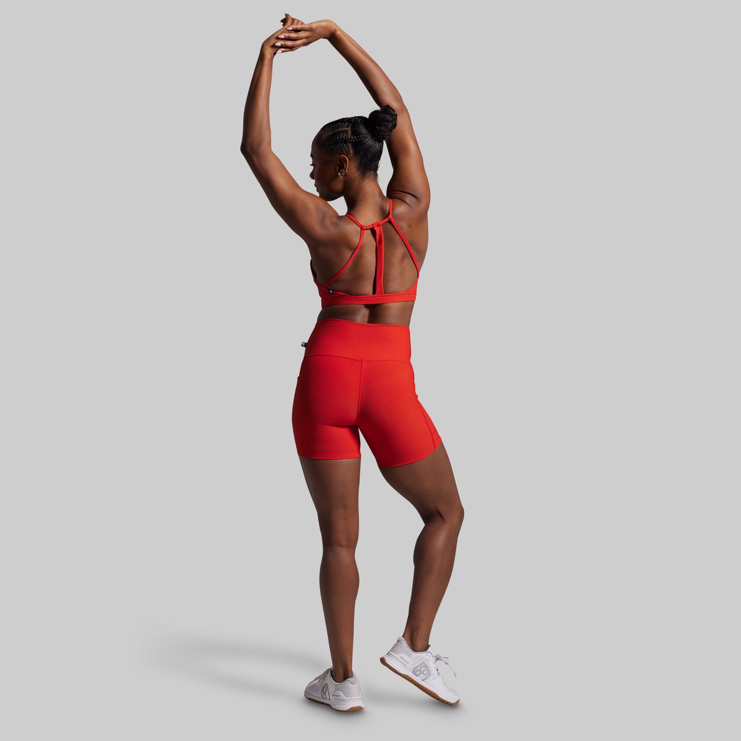 Person wearing a red athletic outfit on a gray background