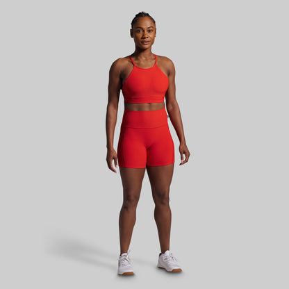 Person wearing a red athletic outfit on a gray background