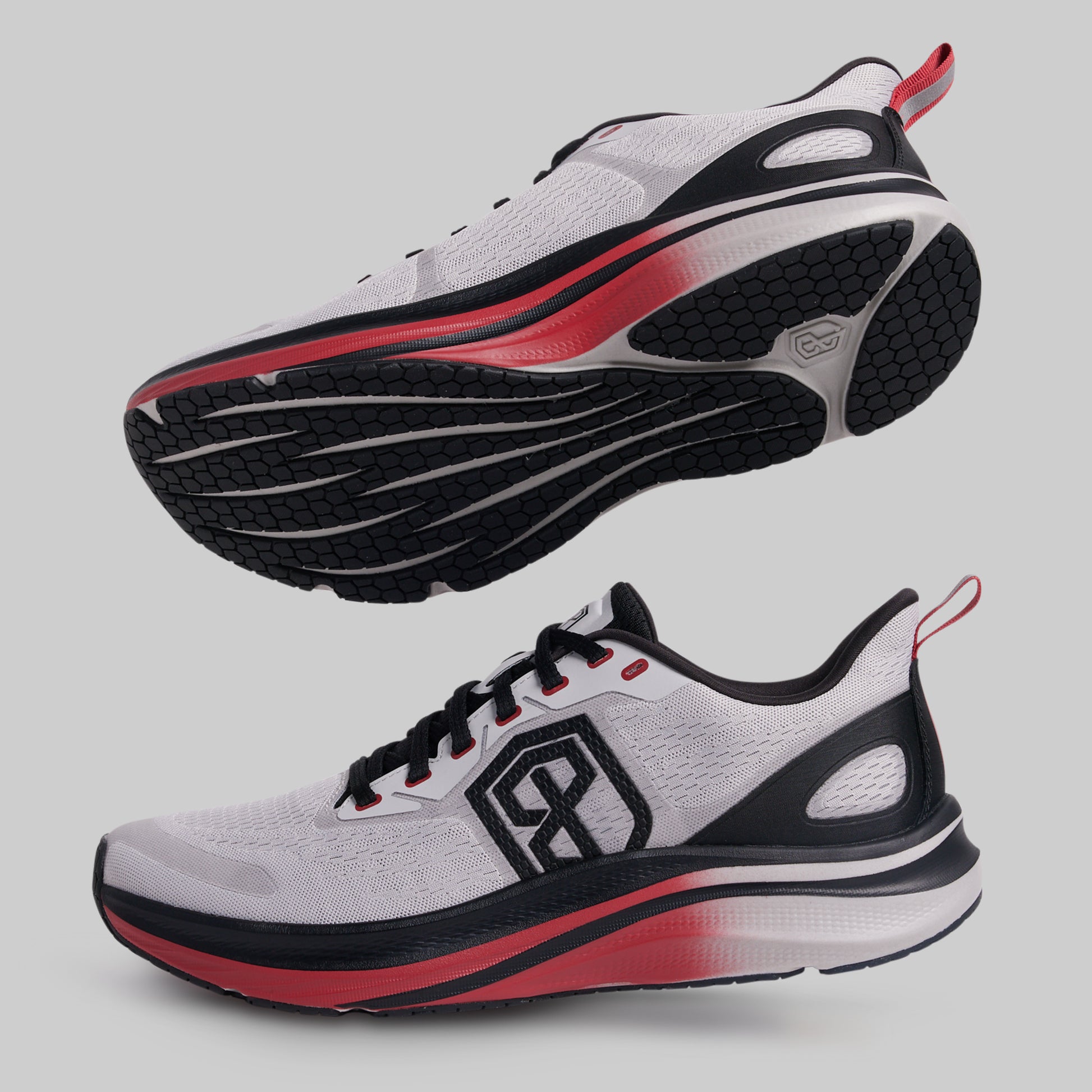 White running shoes with black and red accents on a gray background