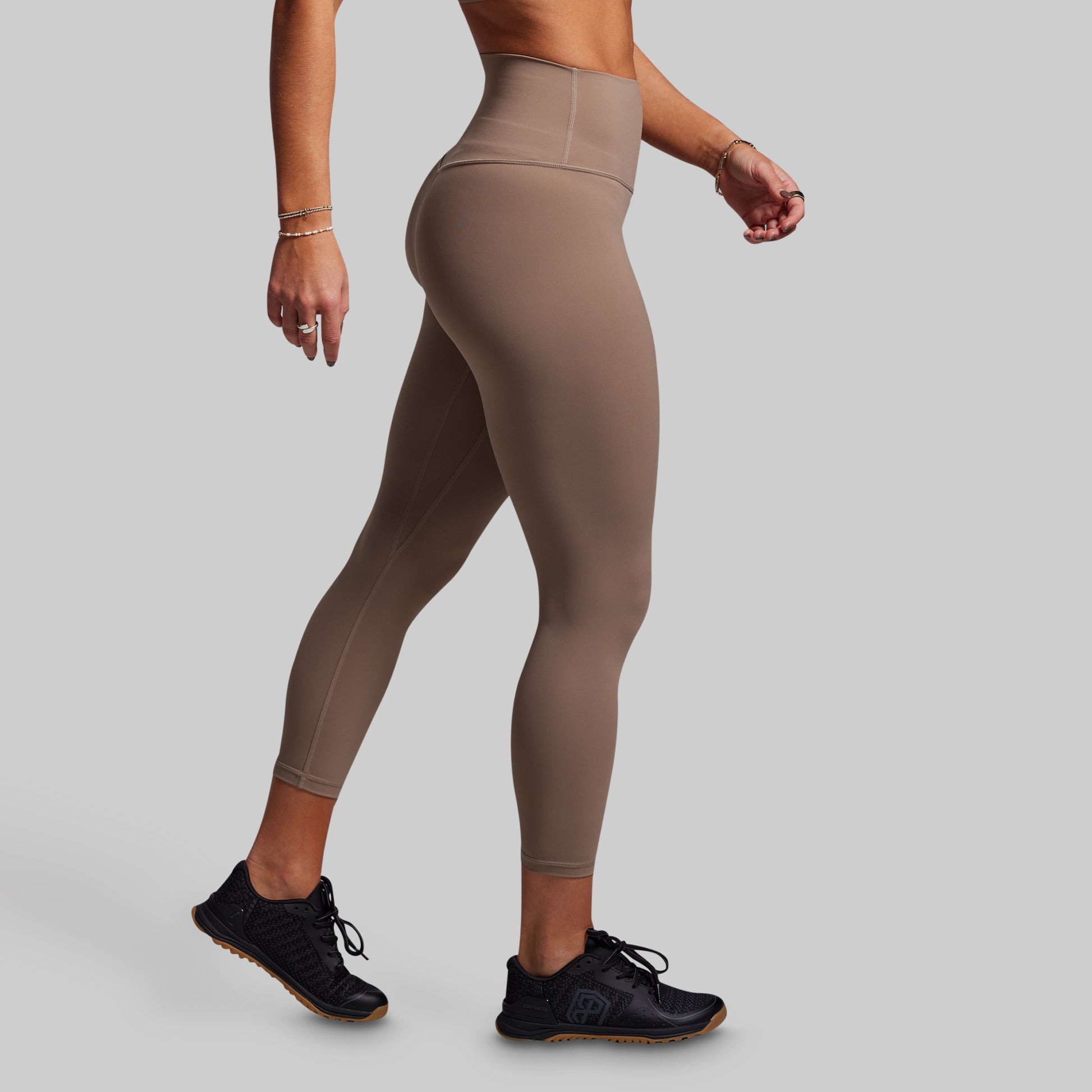 Beige leggings worn by a person on a plain background